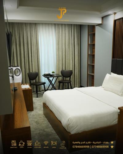 a hotel room with a bed and a table at Al jadriya Palace in Baghdād