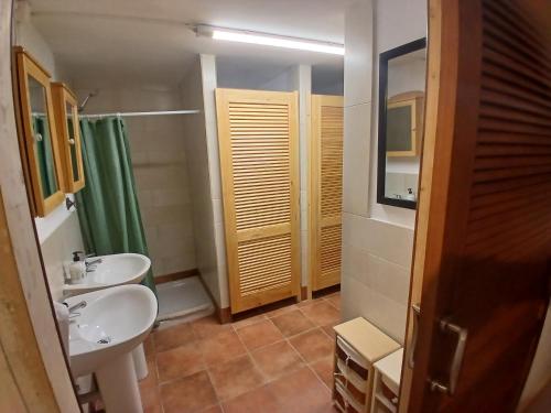 a bathroom with a sink and a toilet and a mirror at Casa Rural Forcén in Lumpiaque