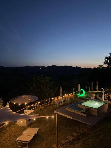 a patio with a swimming pool at night at Poderino - a place to feel in Cento