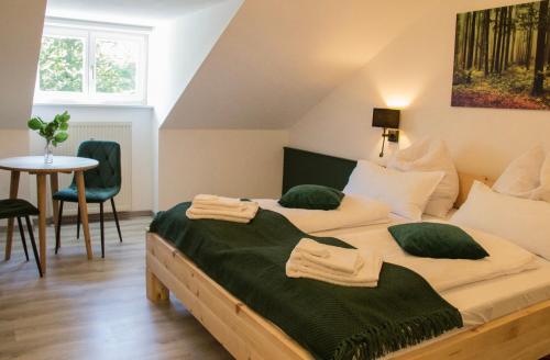 a bedroom with a bed with green pillows on it at Wohlfühlzimmer "Zirbentraum Kampenwand" - self check-in only, no staff on site in Aschau im Chiemgau