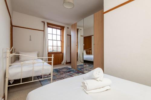 a bedroom with two beds and a window at Corner House - Elie & Earlsferry in Elie