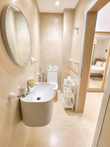 a bathroom with a sink and a mirror at Sables D'or Appart Hôtel in Agadir