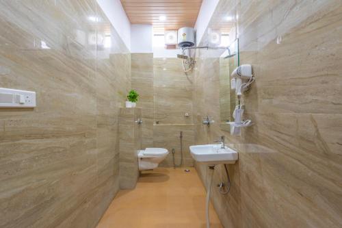 a bathroom with a toilet and a sink at Manas Resort Udaipur in Udaipur