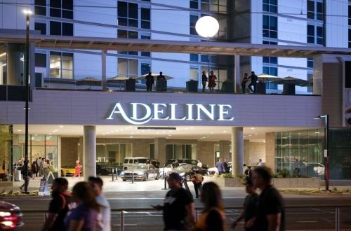 a group of people walking in front of a building at CozySuites at Adeline in Phoenix