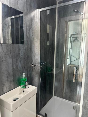 a bathroom with a shower and a toilet and a sink at Victoria Hotel Blackpool in Blackpool