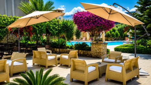 a group of chairs and umbrellas next to a pool at ANADOL Hotel & Pool Central Kyrenia in Temblos