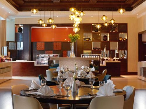 a dining room with a table and chairs at Zamzam Pullman Makkah in Mecca