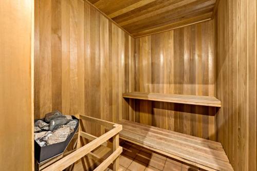 a sauna with a bench in a wooden wall at Tremblant Prestige - Clairiere 406 in Mont-Tremblant