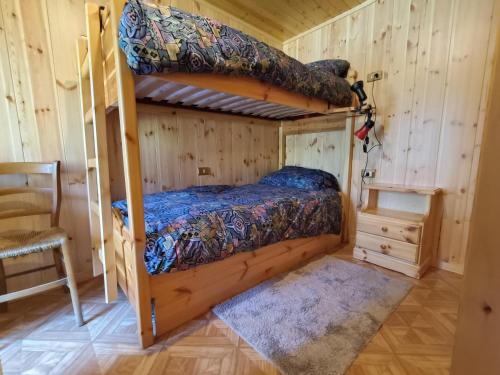 a bedroom with two bunk beds in a cabin at Coldemies apartment in Alleghe
