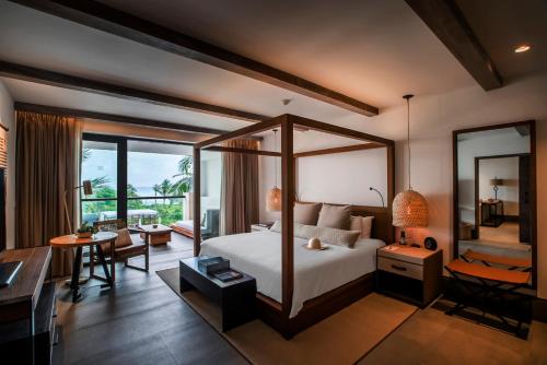 a hotel room with a bed and a desk and a desk at Unico Hotel Riviera Maya Adults Only in Akumal