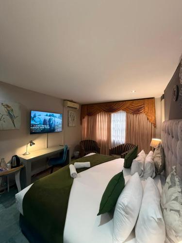 a hotel room with a large bed and a television at Marion Lodge in Johannesburg