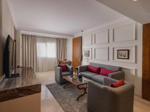 a living room with two couches and a television at Sonesta Hotel Tower & Casino Cairo in Cairo