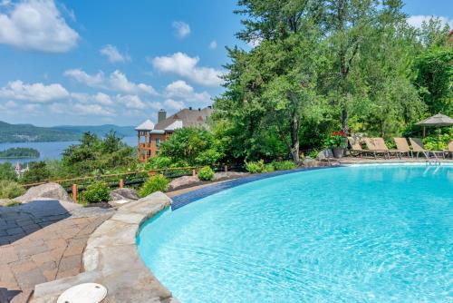 a swimming pool with a view of the water at Tremblant Prestige - Equinoxe 140-1 in Mont-Tremblant
