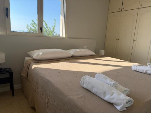 two beds in a bedroom with towels on them at MONTREAL FLAT STUDIO in Reggio di Calabria