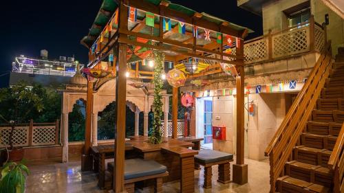 a patio with a table and chairs on a balcony at Jungle by sturmfrei Agra in Agra