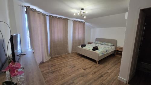 a bedroom with a bed and a television in it at Complex Casa Morii in Orăştie