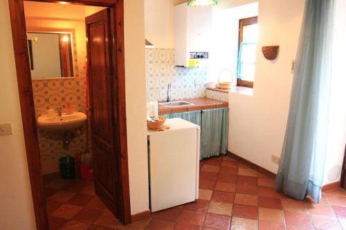 a small kitchen with a sink and a refrigerator at Agriturismo Villa Opera in Volterra