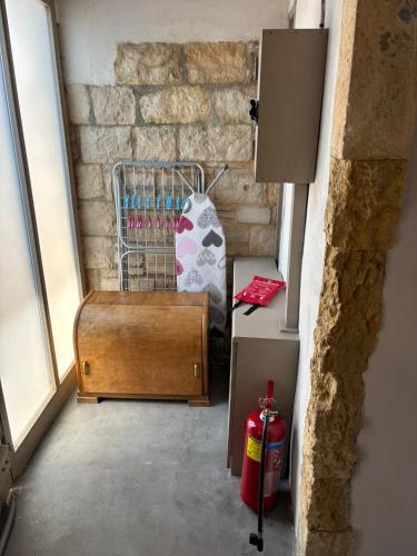 a room with a suitcase next to a brick wall at Meteoron Platanias in Platanias
