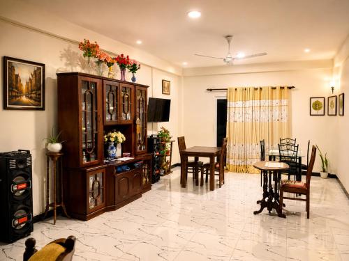 a living room with a table and a dining room at The Continental Hotel in Seeduwa