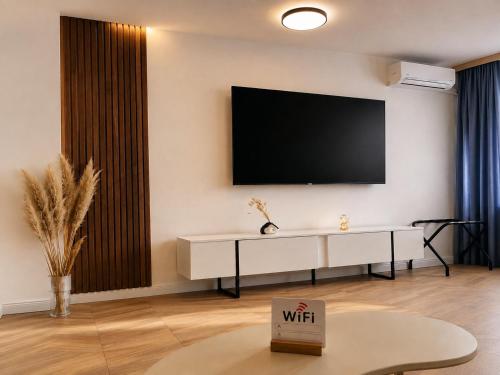 a living room with a tv on the wall at Fontana Lux Apartment in Belgrade