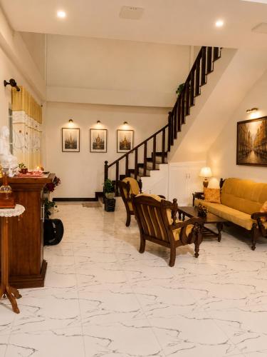 a living room with a couch and a staircase at The Continental Hotel in Seeduwa
