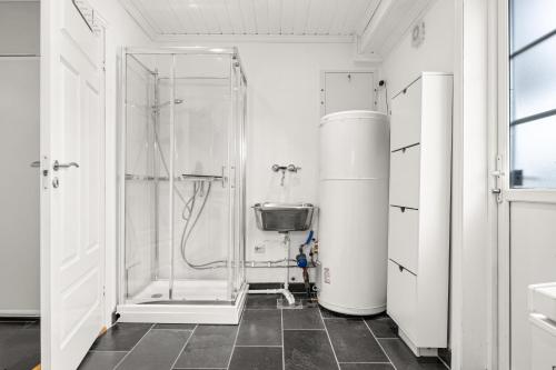 a bathroom with a shower with a glass door at Spectacular nature experience at Norway's southern point! in Svenevik