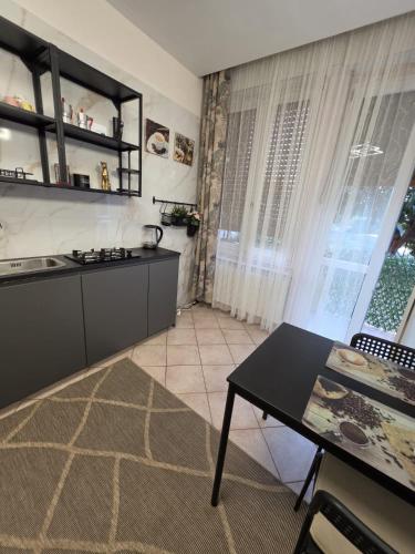 a kitchen with a table and a counter top at Monolocale Liberty in Gorizia