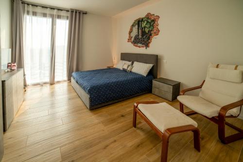 a bedroom with a bed and a couch and a chair at Casa Delle Bollicine in Bigolino