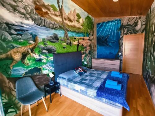 a bedroom with a dinosaur mural on the wall at Nuestro sueño jurásico in Barreiros