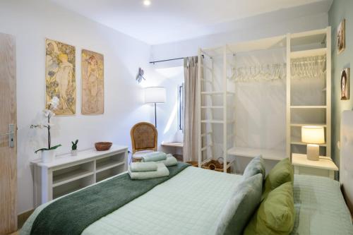 a bedroom with a bed and a desk and shelves at Casa Sherazad in Tías
