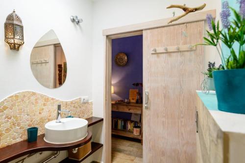 a bathroom with a sink and a mirror at Casa Sherazad in Tías