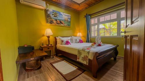 a bedroom with a bed and a window at La Digue Holiday Villa in La Digue