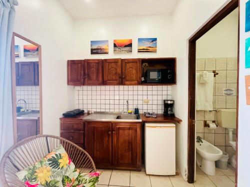 a kitchen with wooden cabinets and a sink at Toro Blanco in Coco