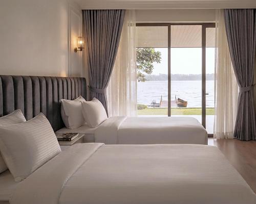 a hotel room with two beds and a window at Aradhana by Nepali in Moratuwa
