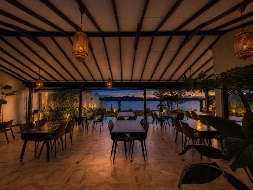 a restaurant with tables and chairs and a view of the water at Aradhana by Nepali in Moratuwa