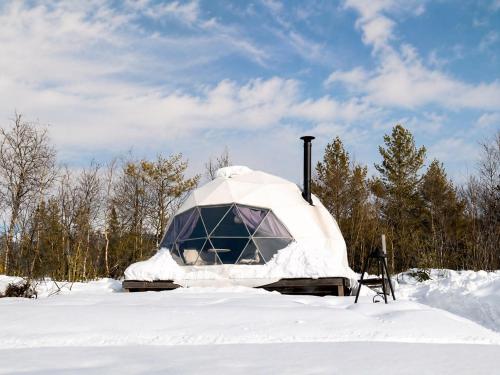 a yurt is covered in snow in a field at Trysil Glamping in Trysil
