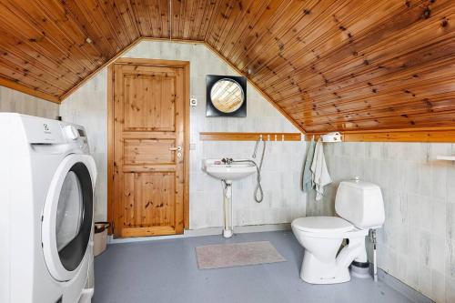 a small bathroom with a toilet and a sink at Shared room in a quiet area in Kallinge