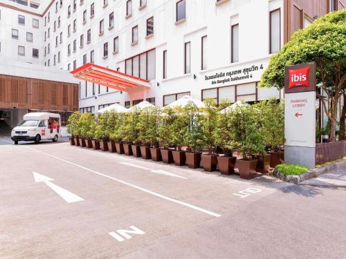 a row of potted plants on the side of a street at Ibis Bangkok Sukhumvit 4 in Bangkok