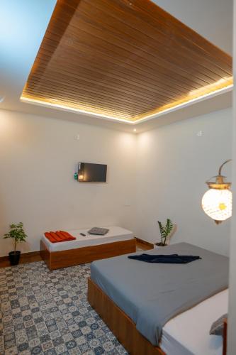 a bedroom with two beds and a skylight at Swastha Royals Wayanad in Kaniyāmbetta