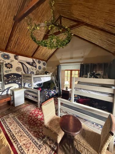 a bedroom with two bunk beds and a table and chairs at Goldeneye Chalet -Hidden Gem of Hartees in Hartbeespoort