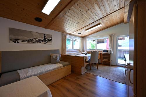 a bedroom with a bed and a desk in a room at Appartements Oberdorfer in Landeck