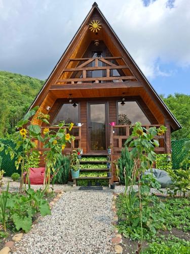 a cabin with a thatched roof and a pathway at WILD NEST Cottage 