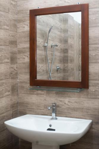 a bathroom mirror with a sink and a shower at Villa Downsouth Nilaveli in Kumpurupiddi