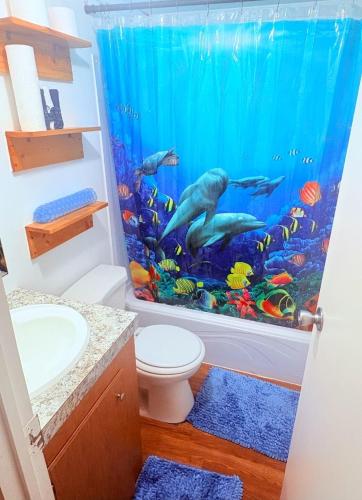 a bathroom with a mermaid shower curtain at Peace in Lake Hartwell in Hartwell