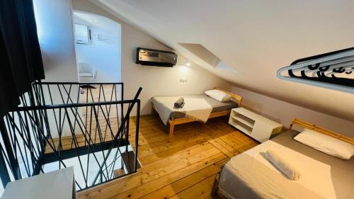 a small room with two beds and a staircase at Regina Maris in Betina