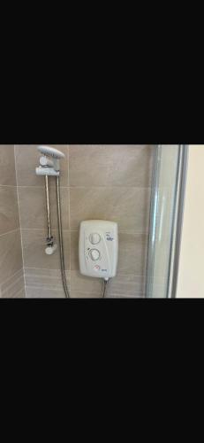 a bathroom with a shower and a soap dispenser at The Urban Haven in Limerick