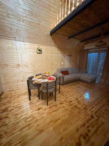 a living room with a table and a couch at Eco house luma in K'eda