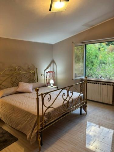 a bedroom with a bed and a large window at A casa di Lea2 in Gioia dei Marsi