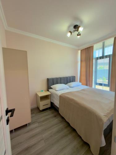 a bedroom with a large bed and a window at M&M Hotel in Pʼarakʼar