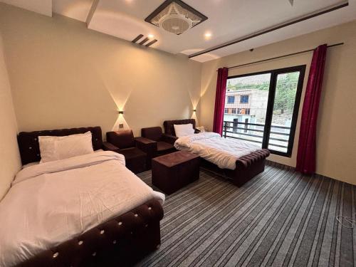 a hotel room with a bed and a couch at Gold Star Hotel Skardu in Skardu